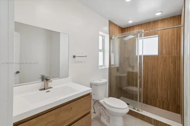 a bathroom with a sink toilet and shower