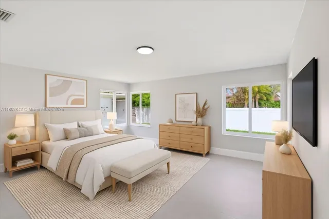 a bedroom with a bed and a flat screen tv