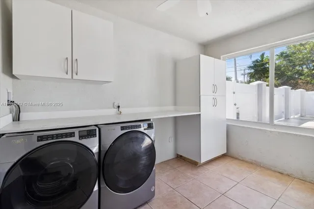 a utility room with sink dryer and washer