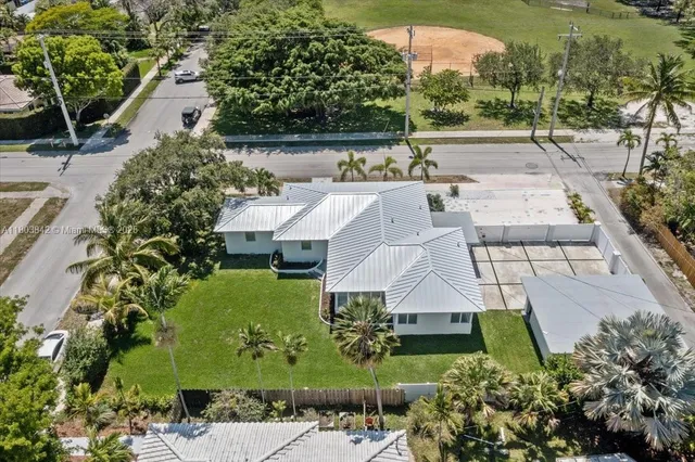an aerial view of a house with a yard and lake view