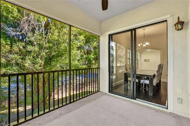 a view of a hallway with wooden floor and windows