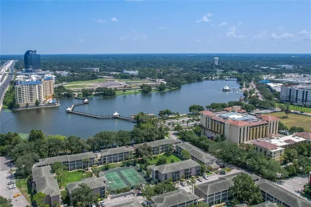 an aerial view of a house with a garden and lake view