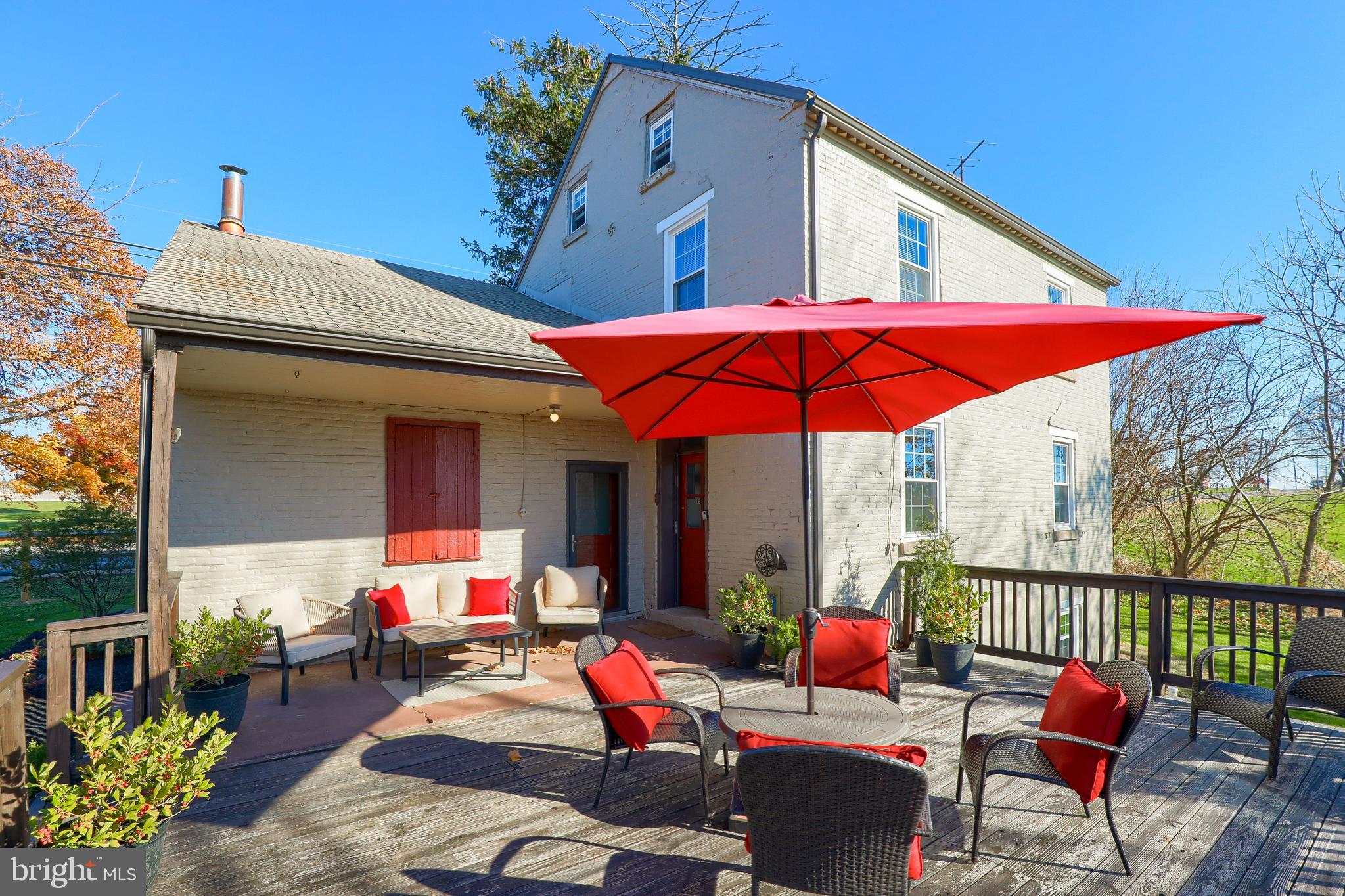 636-640 Doe Run Road Lititz, PA 17543 - Photo 3 of 34 a view of a patio with a table and chairs under an umbrella