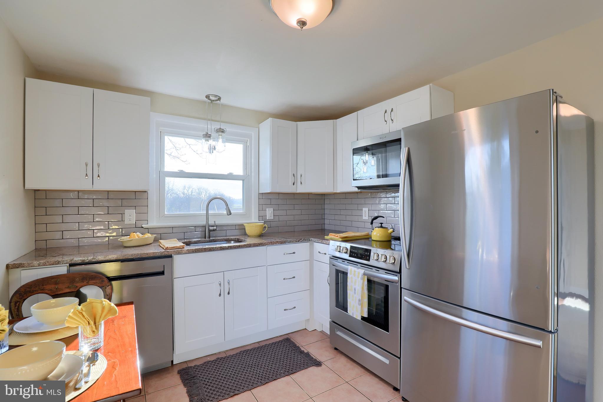 636-640 Doe Run Road Lititz, PA 17543 - Photo 7 of 34 a kitchen with a refrigerator sink and cabinets