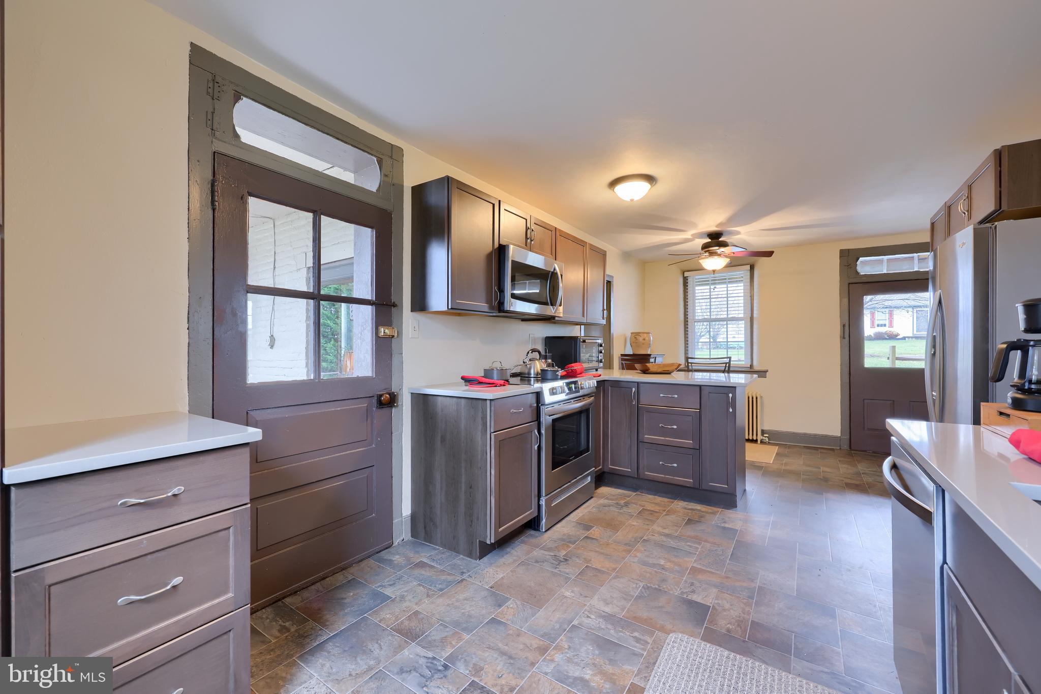 636-640 Doe Run Road Lititz, PA 17543 - Photo 10 of 34 a kitchen with stainless steel appliances kitchen island granite countertop a refrigerator stove and sink