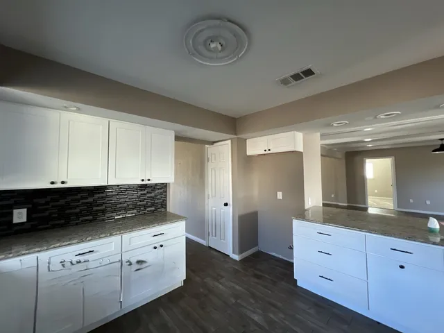 a view of a lot of cabinets and wooden floor