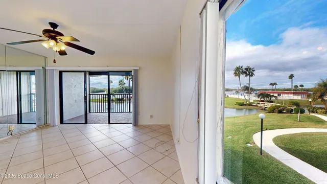 a view of a living room and chandelier fan