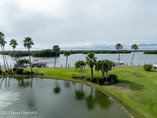 a view of a lake with couches with wooden floor and lake view