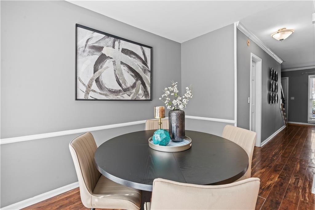 1101 Collier Road Northwest, Unit D5 Atlanta, GA 30318 - Photo 13 of 38 a dining room with furniture and wooden floor