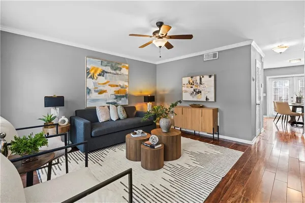 a living room with furniture flowers and a chandelier