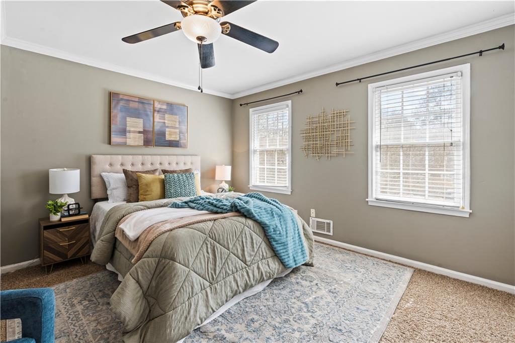 1101 Collier Road Northwest, Unit D5 Atlanta, GA 30318 - Photo 17 of 38 a bedroom with a bed and wooden floor