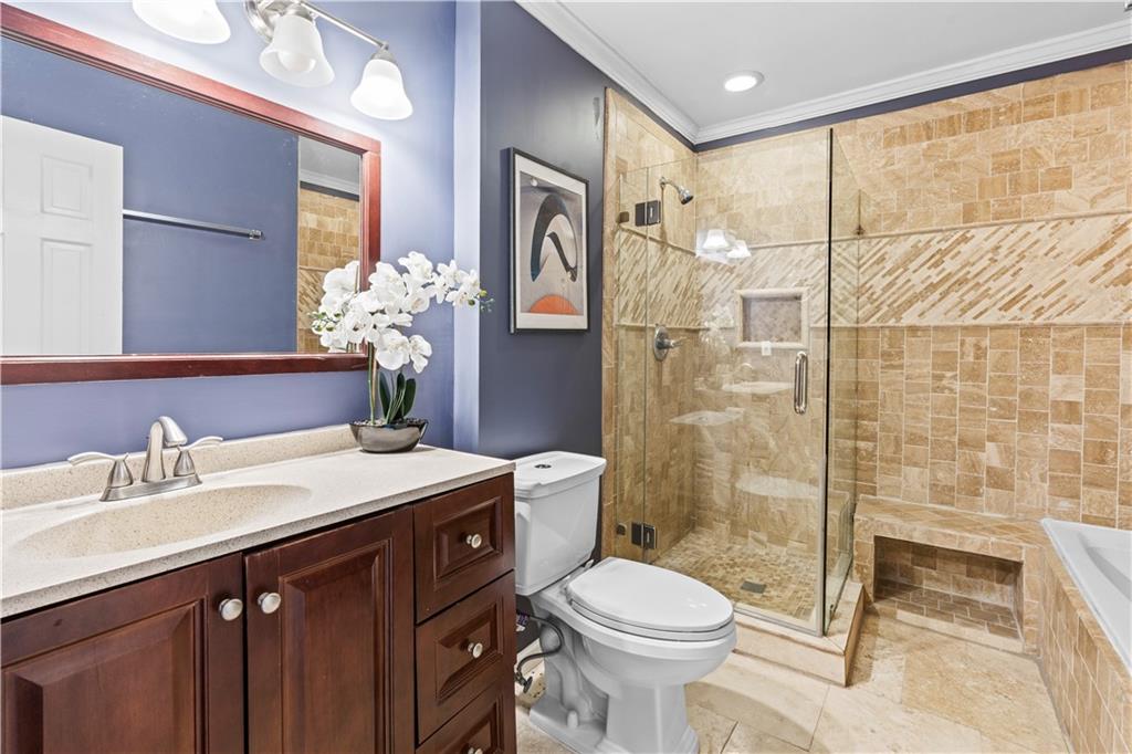 1101 Collier Road Northwest, Unit D5 Atlanta, GA 30318 - Photo 10 of 38 a bathroom with a sink a toilet and shower