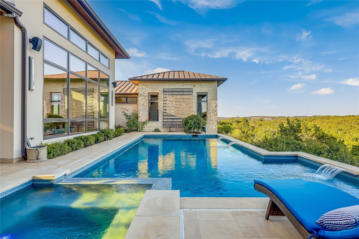 a view of swimming pool with seating area