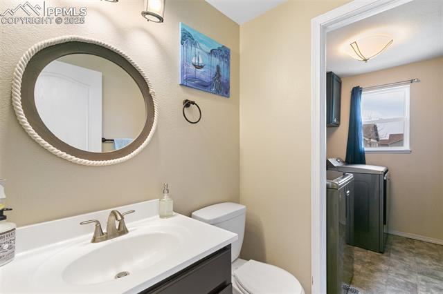 8291 Tibbs Road Peyton, CO 80831 - Photo 18 of 25 1/2 bath looking into the washer and dryer