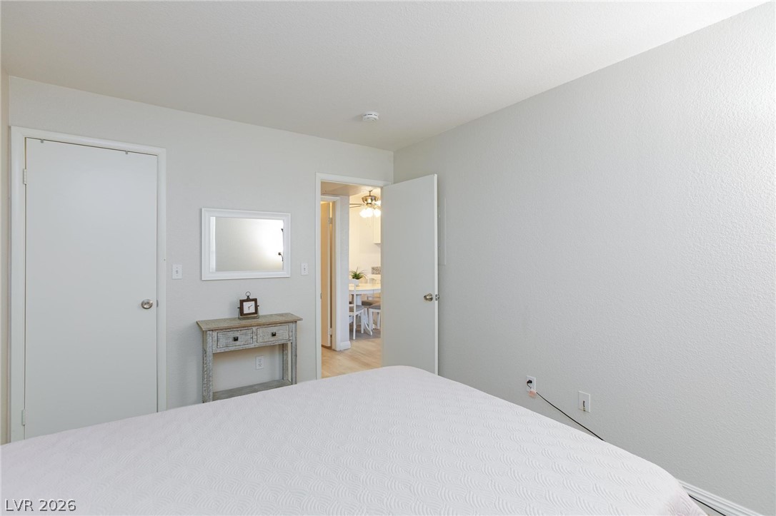5171 South Lindell Road, Unit 103 Las Vegas, NV 89118 - Photo 16 of 24 An inviting sleeping space with bright walls opens to an adjacent dining area.