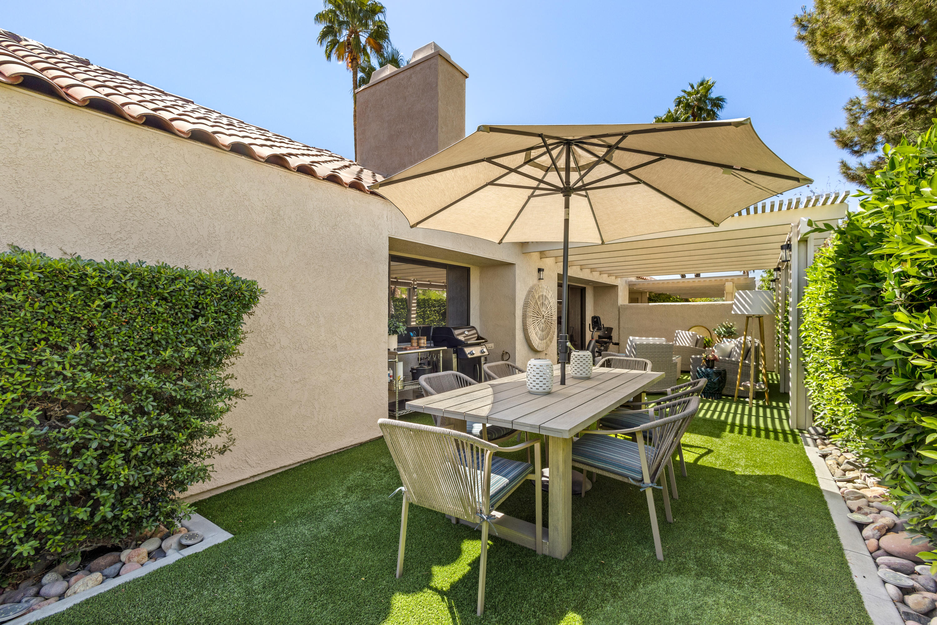 303 Forest Hills Drive Rancho Mirage, CA 92270 - Photo 13 of 72 a table and chairs in the garden