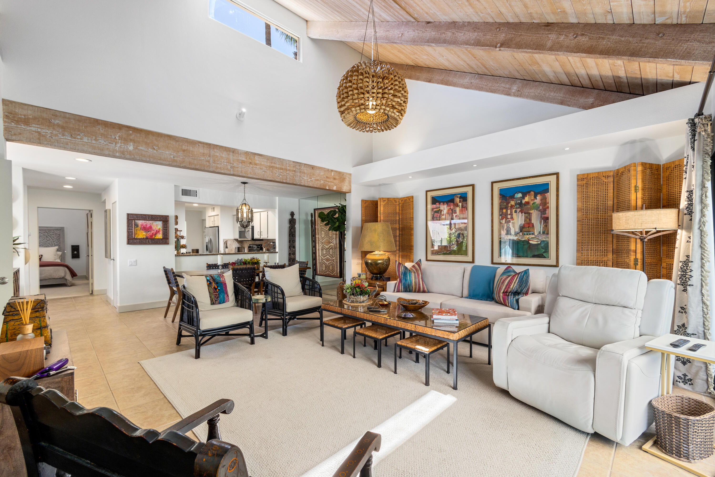 303 Forest Hills Drive Rancho Mirage, CA 92270 - Photo 19 of 72 a living room with furniture a chandelier and a large window