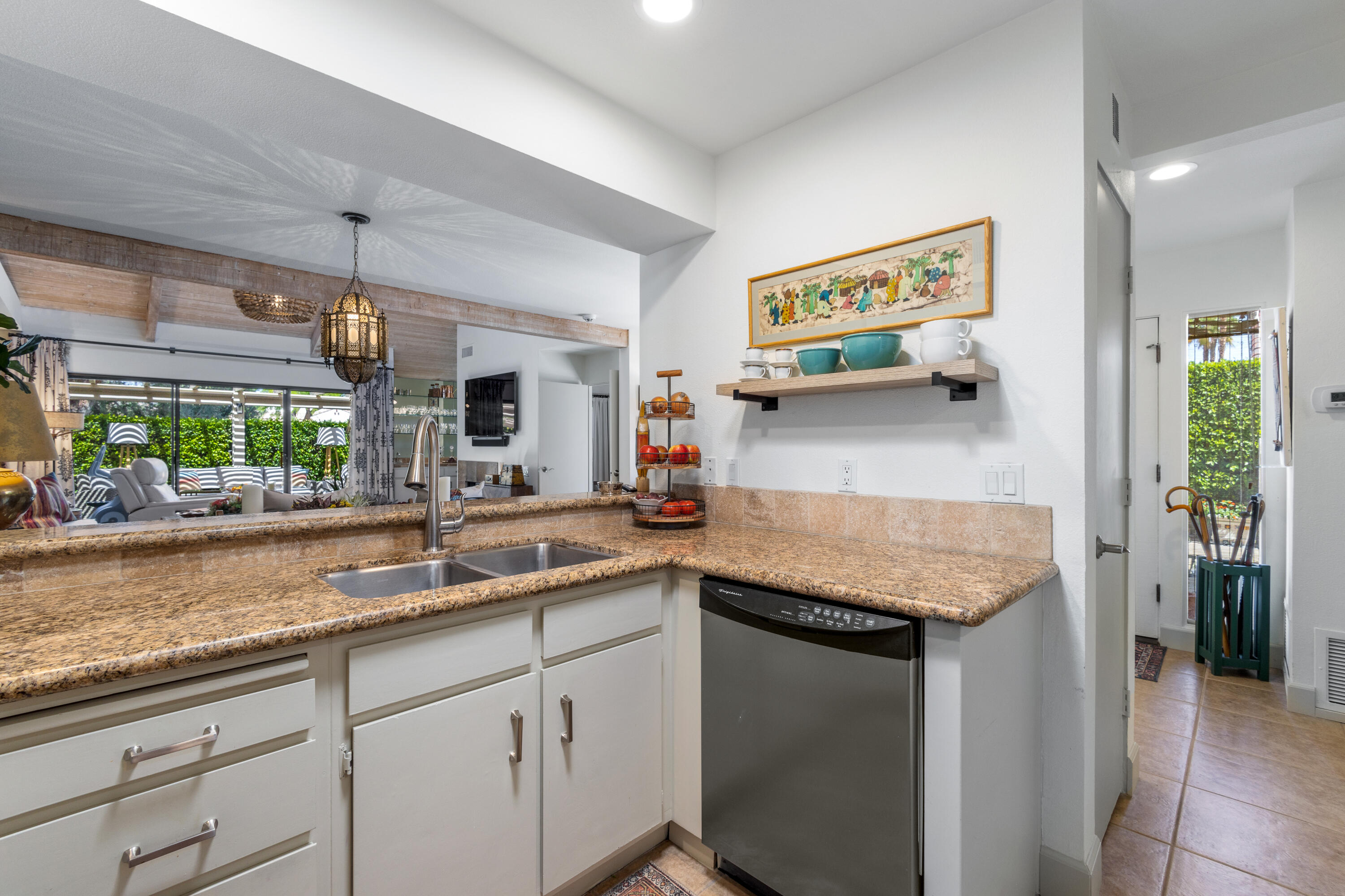 303 Forest Hills Drive Rancho Mirage, CA 92270 - Photo 31 of 72 a kitchen with stainless steel appliances granite countertop a sink and a white cabinets