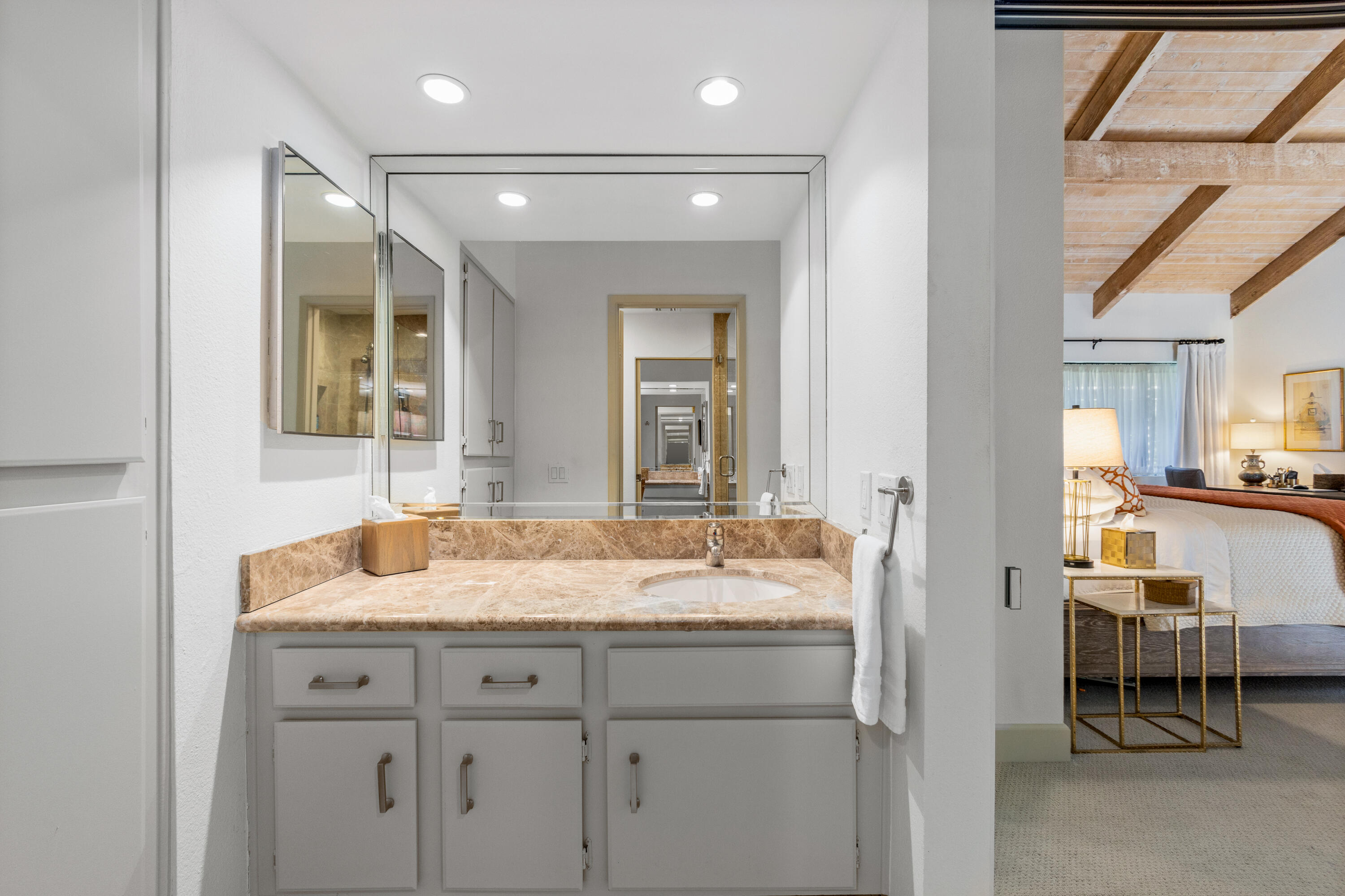 303 Forest Hills Drive Rancho Mirage, CA 92270 - Photo 42 of 72 a bathroom with a granite countertop sink and a mirror