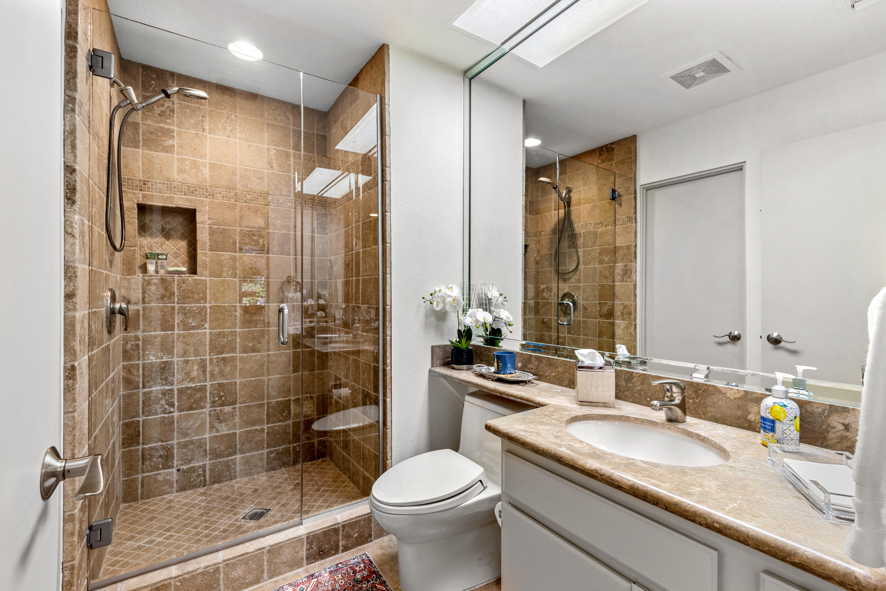 303 Forest Hills Drive Rancho Mirage, CA 92270 - Photo 49 of 72 a bathroom with a sink a toilet and shower