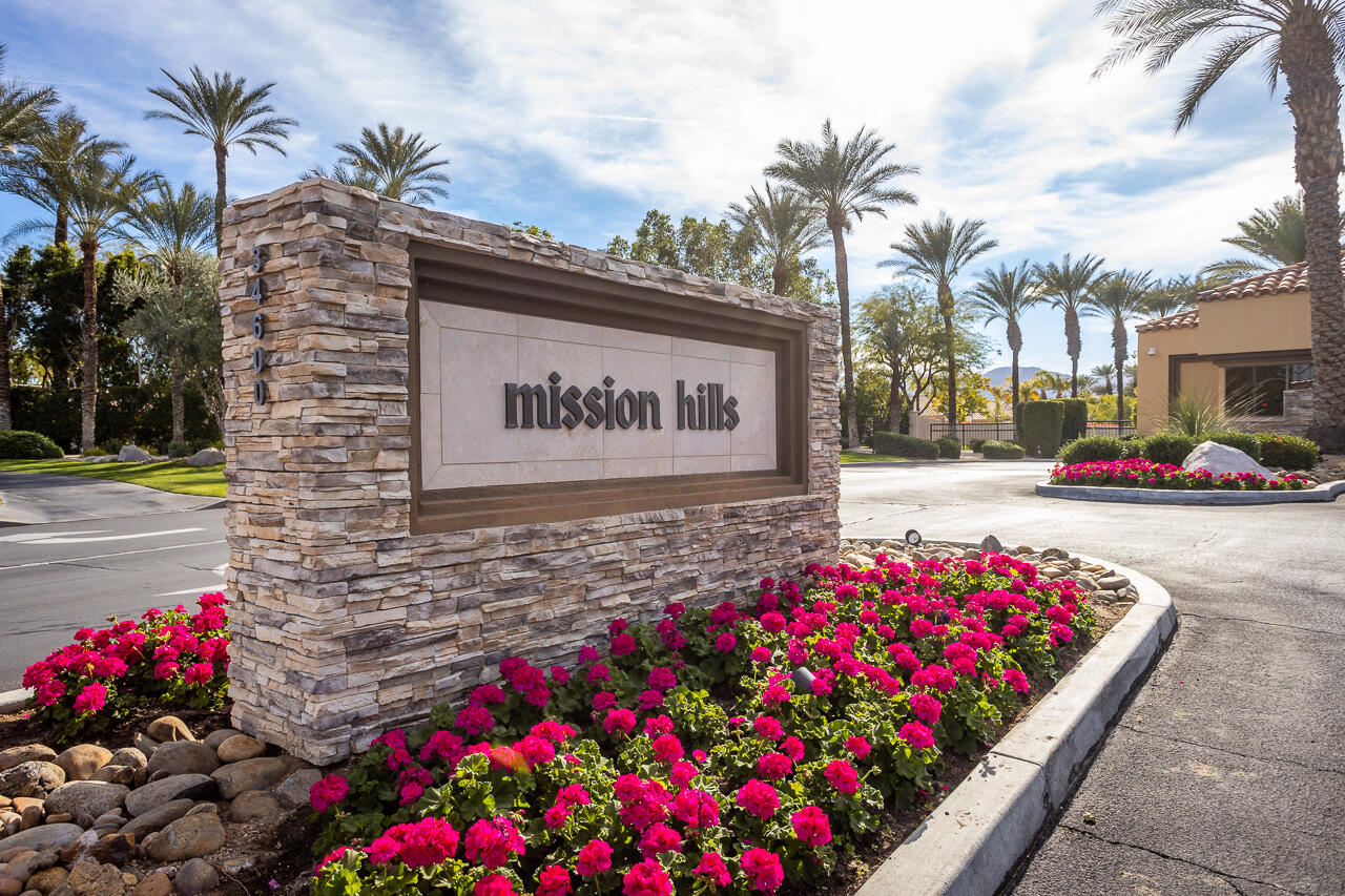 303 Forest Hills Drive Rancho Mirage, CA 92270 - Photo 66 of 72 a street sign that is in front of flowers