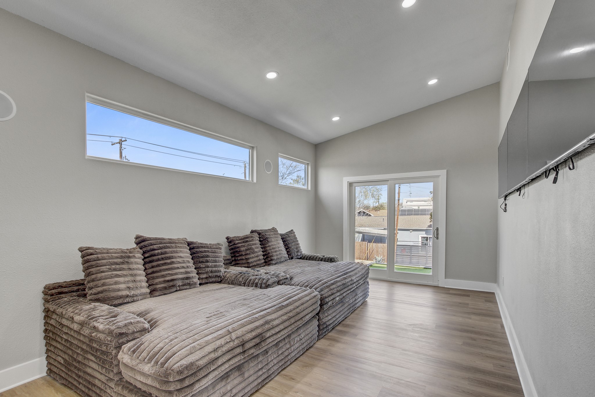 4703 Louis Avenue, Unit A Austin, TX 78721 - Photo 28 of 35 Living area featuring light wood finished floors, lofted ceiling, and recessed lighting