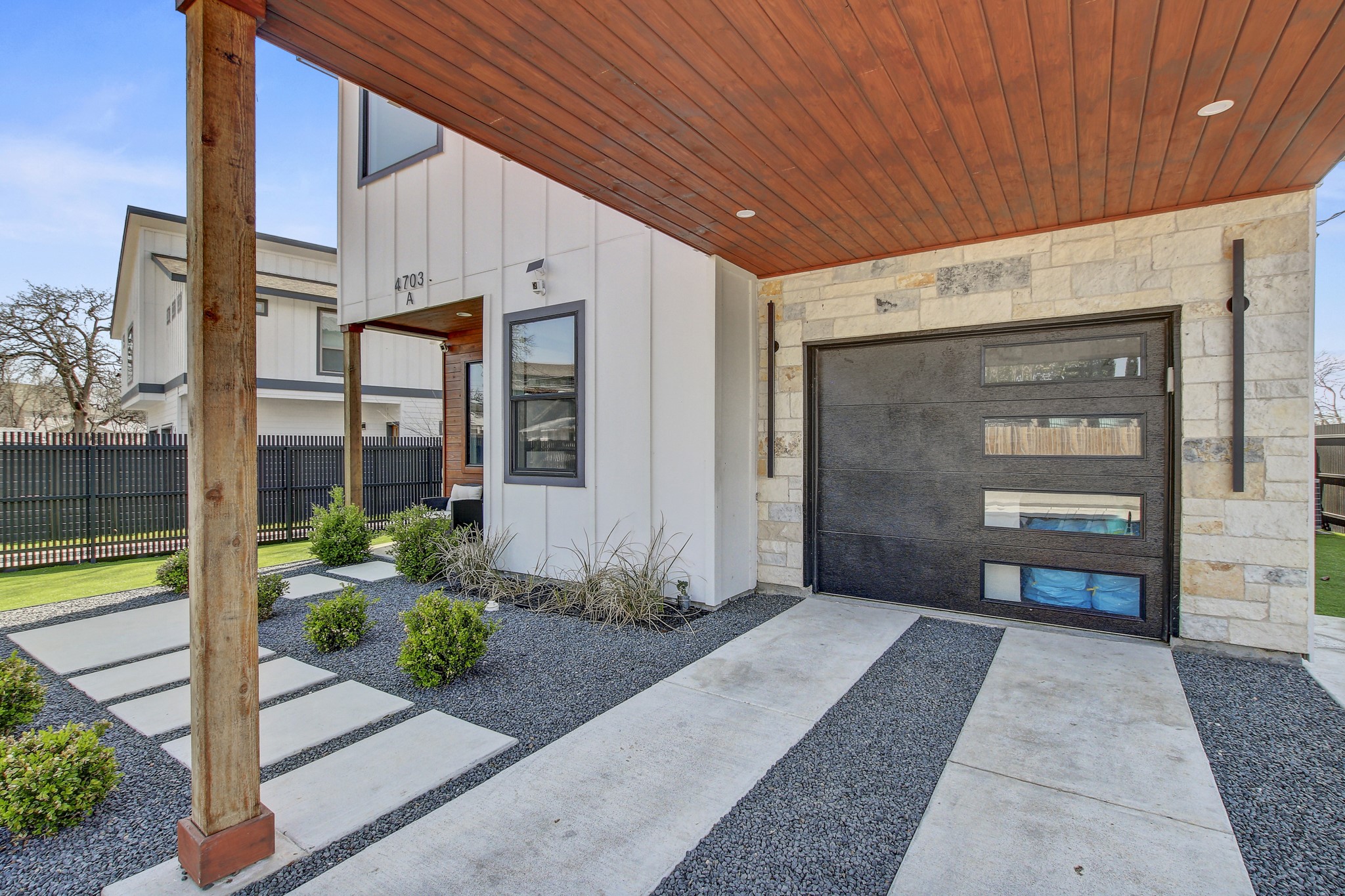 4703 Louis Avenue, Unit A Austin, TX 78721 - Photo 33 of 35 View of exterior entry featuring stone siding and board and batten siding