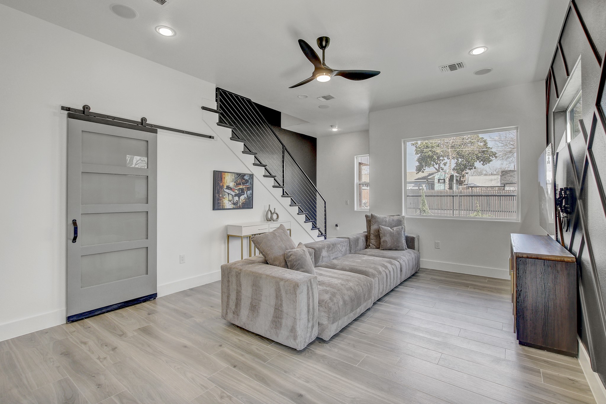 4703 Louis Avenue, Unit A Austin, TX 78721 - Photo 6 of 35 Living room with a barn door, a ceiling fan, light wood finished floors, and recessed lighting