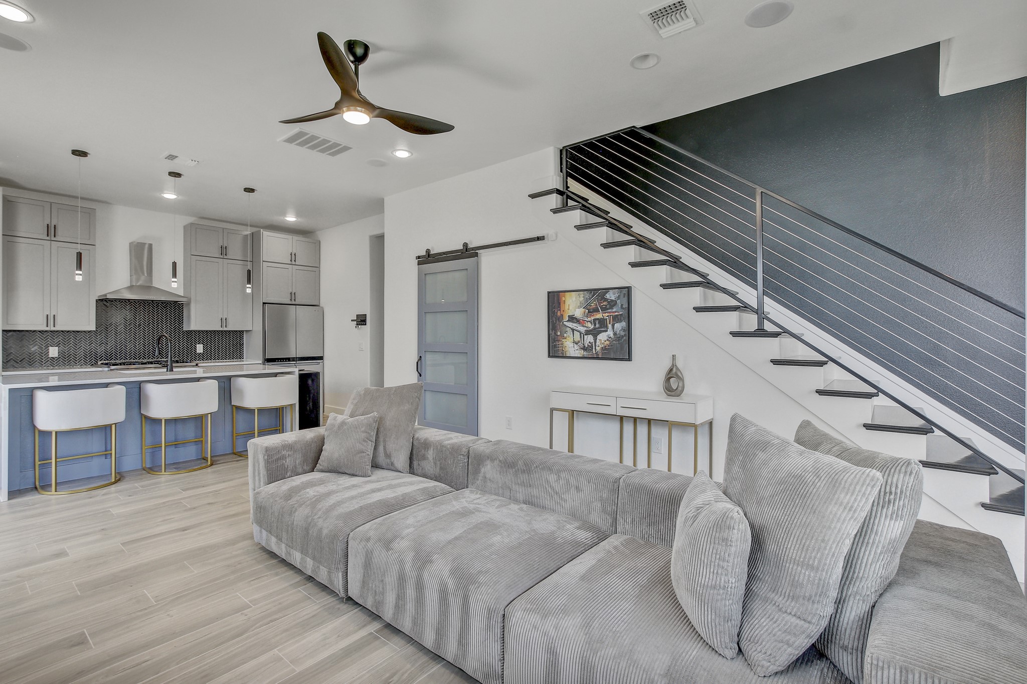 4703 Louis Avenue, Unit A Austin, TX 78721 - Photo 7 of 35 Living area featuring a barn door, a ceiling fan, light wood-style floors, and recessed lighting