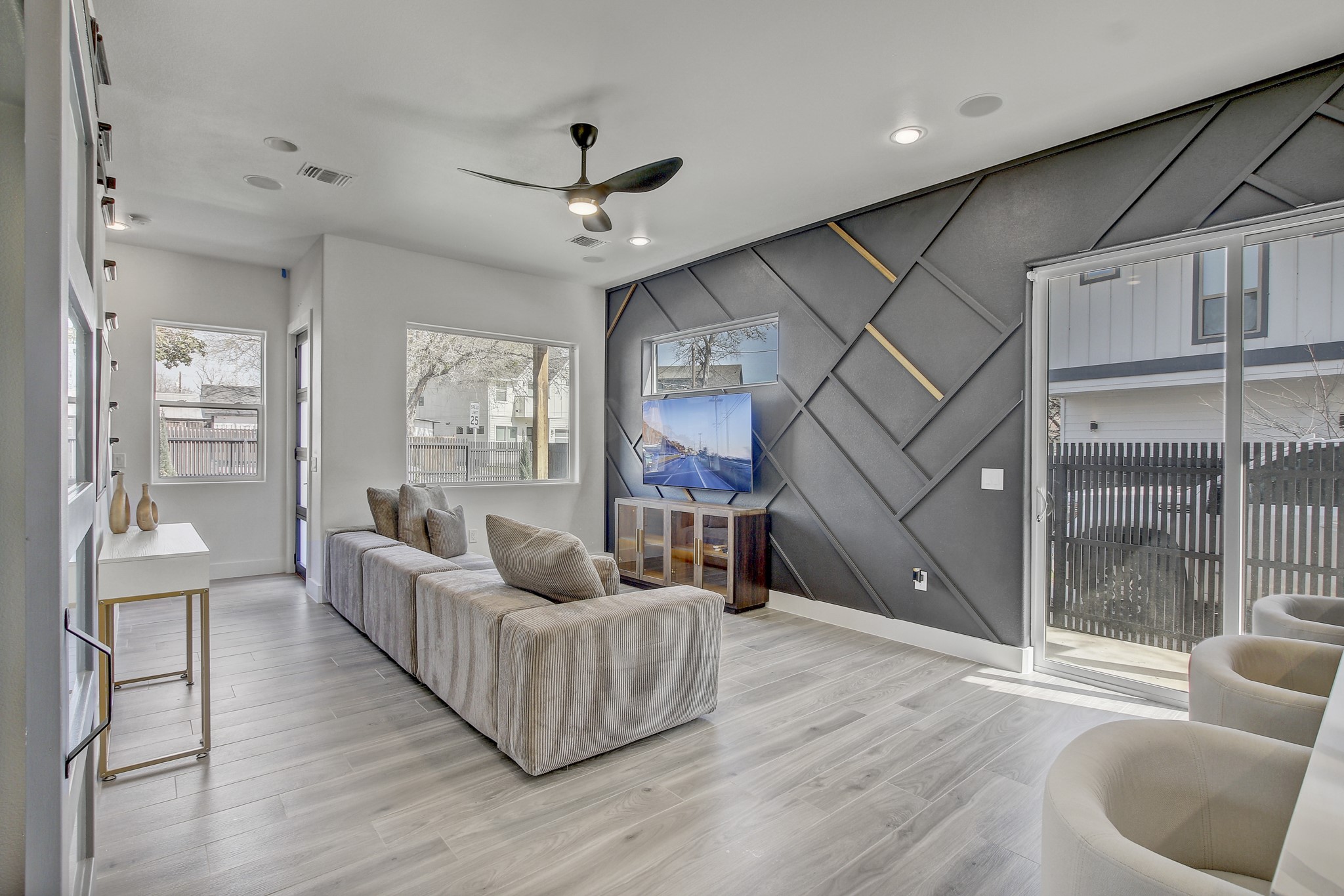 4703 Louis Avenue, Unit A Austin, TX 78721 - Photo 8 of 35 Living area featuring a decorative wall, a ceiling fan, light wood-type flooring, an accent wall, and recessed lighting