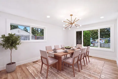 a view of a dining room with furniture window and wooden floor