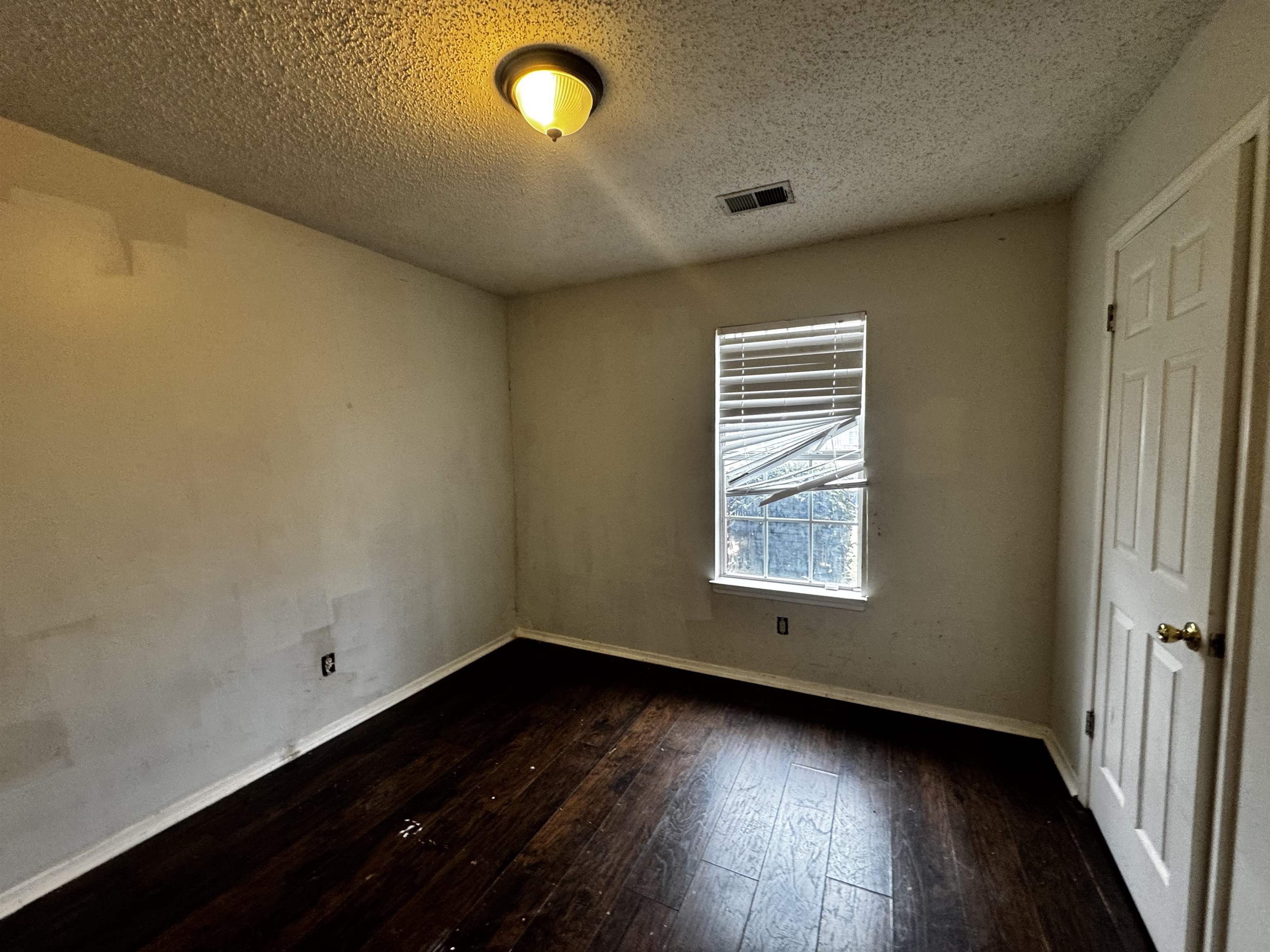 5840 Hickory Shadow Lane Memphis, TN 38141 - Photo 10 of 11 an empty room with wooden floor and windows