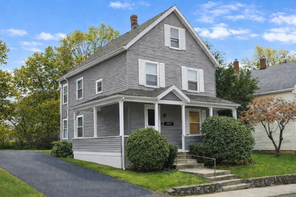 58 Bennett Street, Unit 1 Wakefield, MA 01880 - Photo 1 of 17 a front view of a house with a yard