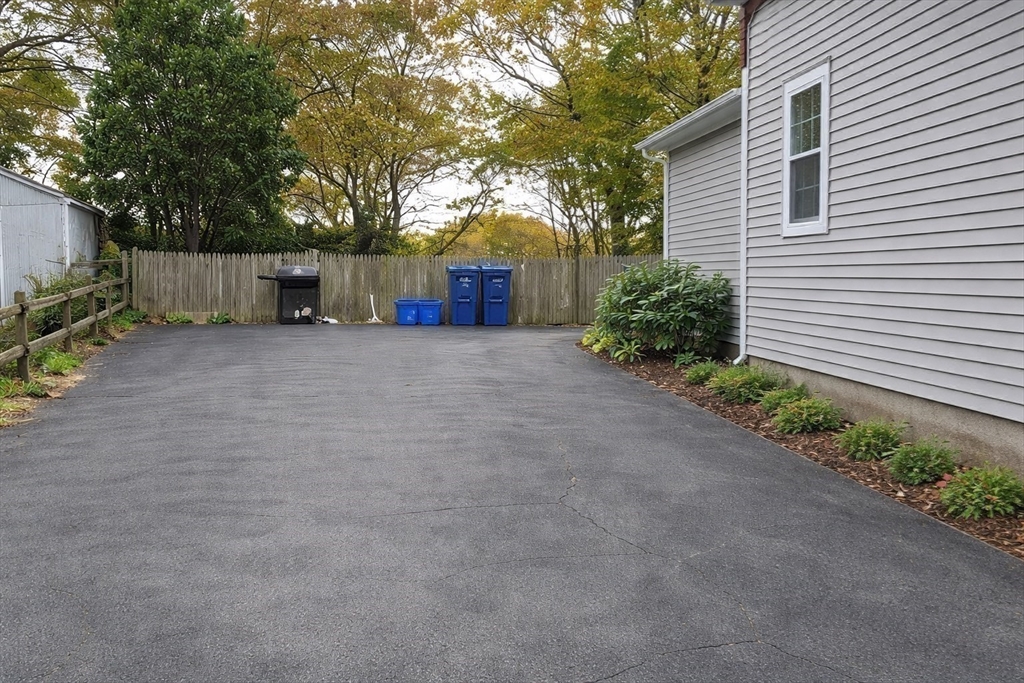 58 Bennett Street, Unit 1 Wakefield, MA 01880 - Photo 13 of 17 a front view of a house with a yard and garage