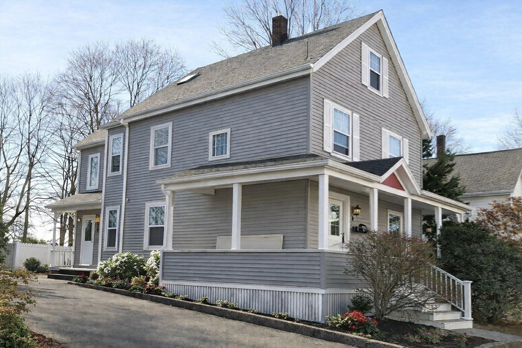 58 Bennett Street, Unit 1 Wakefield, MA 01880 - Photo 14 of 17 a front view of a house with a yard