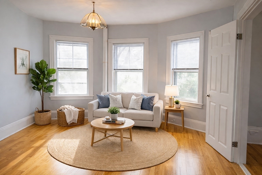 58 Bennett Street, Unit 1 Wakefield, MA 01880 - Photo 2 of 17 a living room with furniture and a chandelier