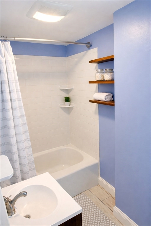 58 Bennett Street, Unit 1 Wakefield, MA 01880 - Photo 7 of 17 a bathroom with a bathtub and a shower