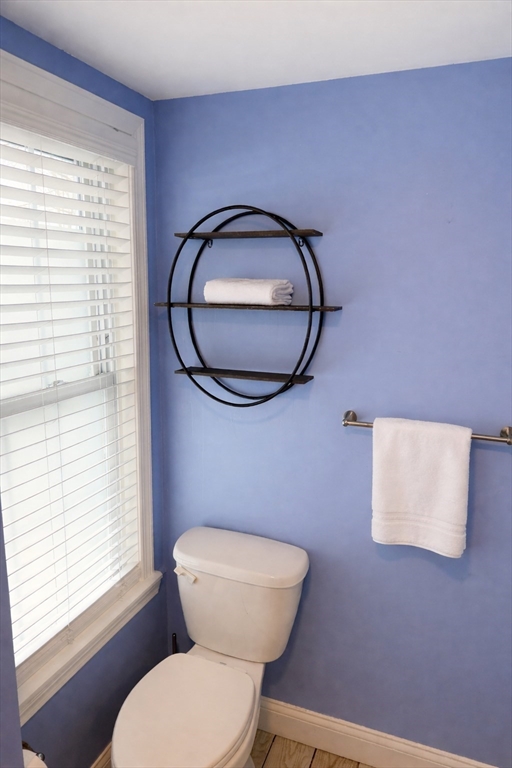 58 Bennett Street, Unit 1 Wakefield, MA 01880 - Photo 8 of 17 a bathroom with a toilet a sink and a window