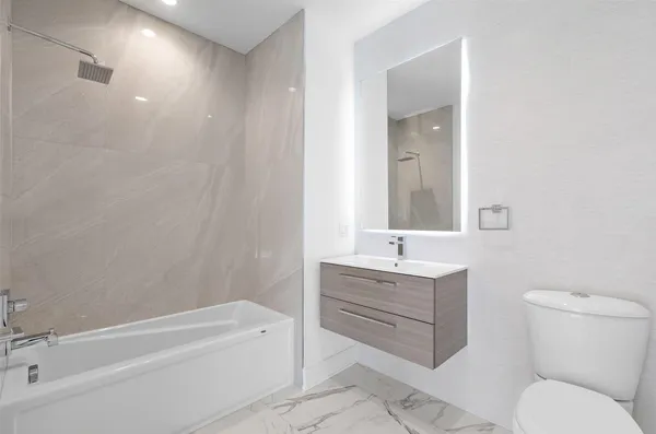 a bathroom with a sink toilet and bathtub