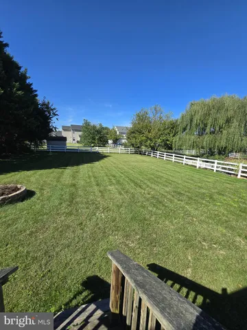 a view of a green field with an ocean