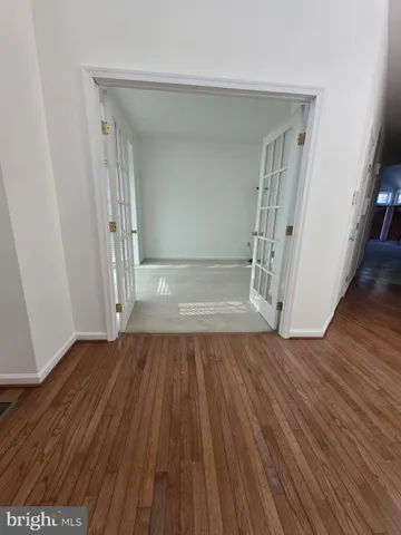 wooden floor in a hall with an empty room
