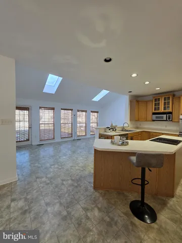 a view of a kitchen with a sink and wooden floor