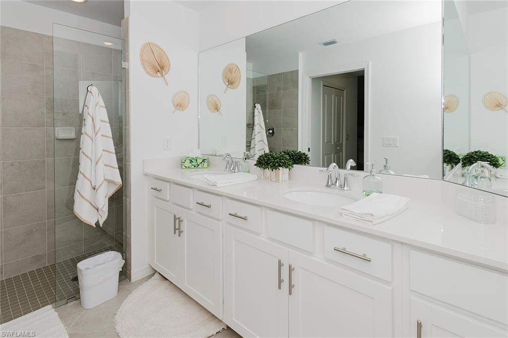 5445 Double Eagle Circle, Unit 3013 Ave Maria, FL 34142 - Photo 11 of 41 a bathroom with a sink and mirror with toilet