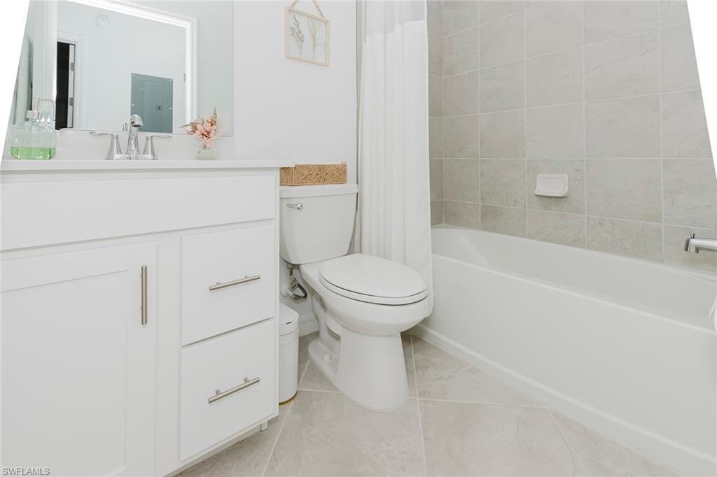 5445 Double Eagle Circle, Unit 3013 Ave Maria, FL 34142 - Photo 13 of 41 a bathroom with a sink a toilet and a bathtub