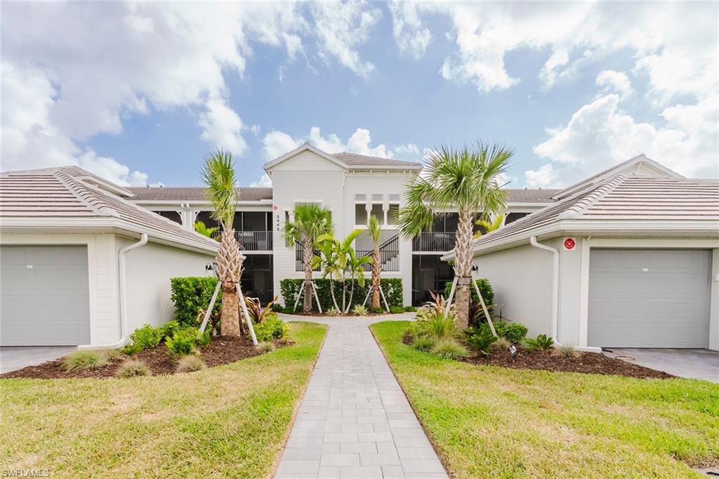 5445 Double Eagle Circle, Unit 3013 Ave Maria, FL 34142 - Photo 19 of 41 a front view of a house with garden