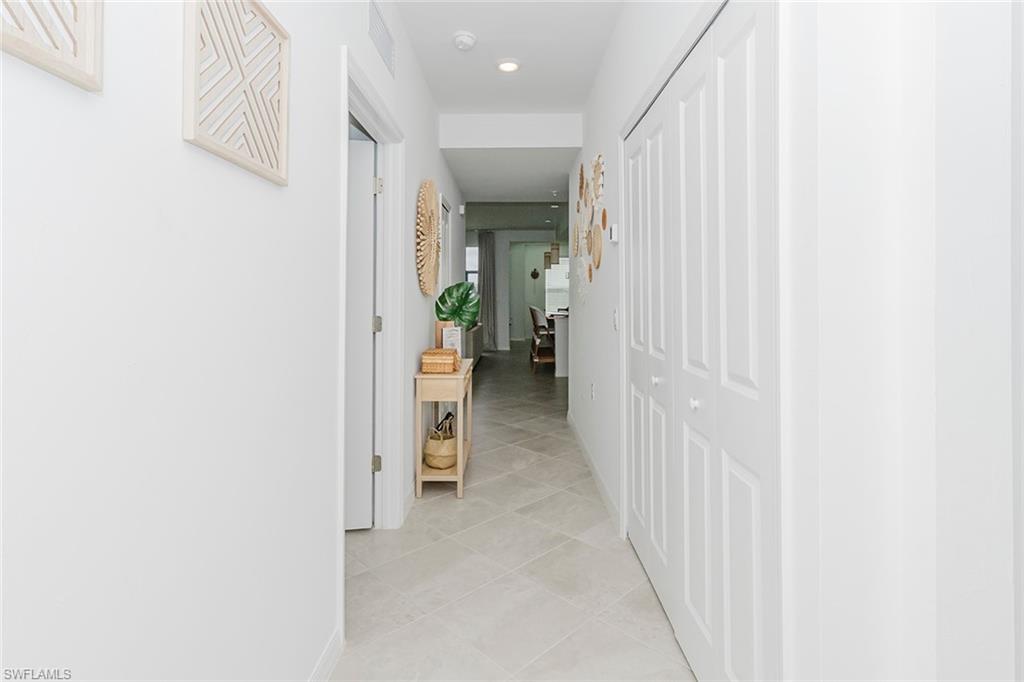 5445 Double Eagle Circle, Unit 3013 Ave Maria, FL 34142 - Photo 25 of 41 a view of a hallway with wooden shelves