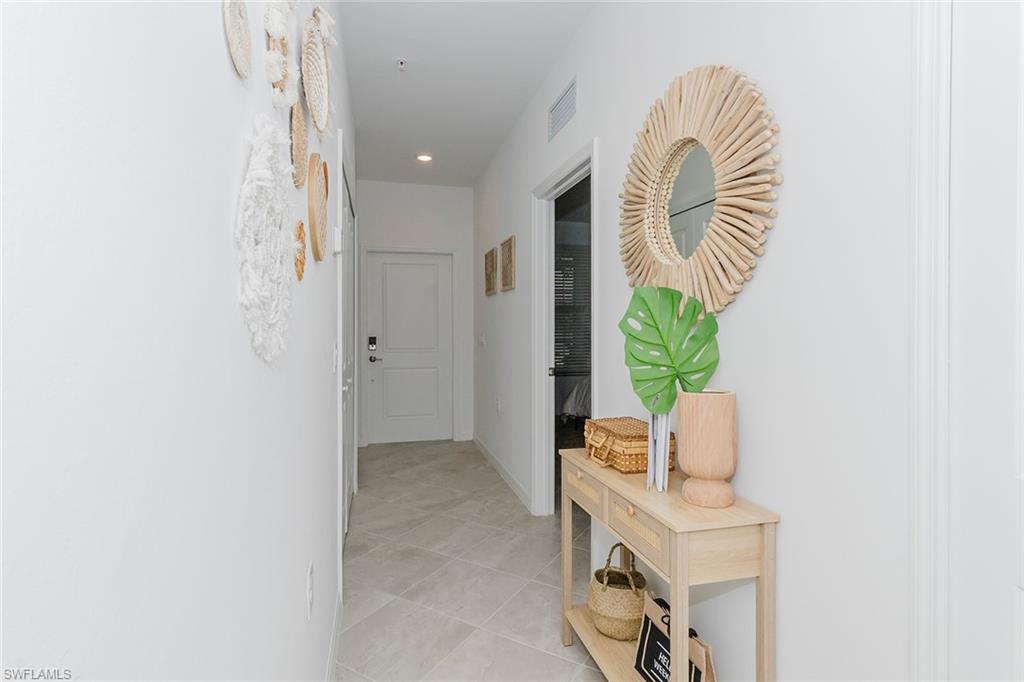 5445 Double Eagle Circle, Unit 3013 Ave Maria, FL 34142 - Photo 26 of 41 a very nice looking room with a white chair