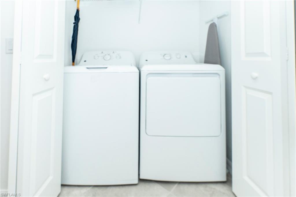 5445 Double Eagle Circle, Unit 3013 Ave Maria, FL 34142 - Photo 27 of 41 a utility room with dryer and washer