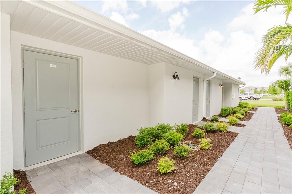 5445 Double Eagle Circle, Unit 3013 Ave Maria, FL 34142 - Photo 29 of 41 a view of a entryway with flower pots