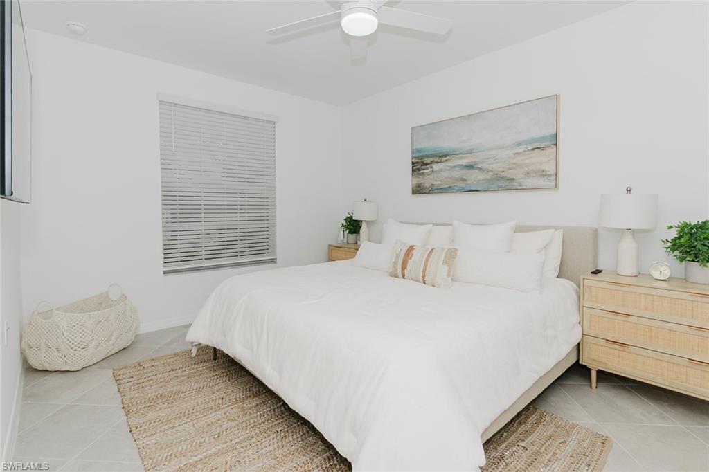 5445 Double Eagle Circle, Unit 3013 Ave Maria, FL 34142 - Photo 6 of 41 a bedroom with a bed and a painting on the wall